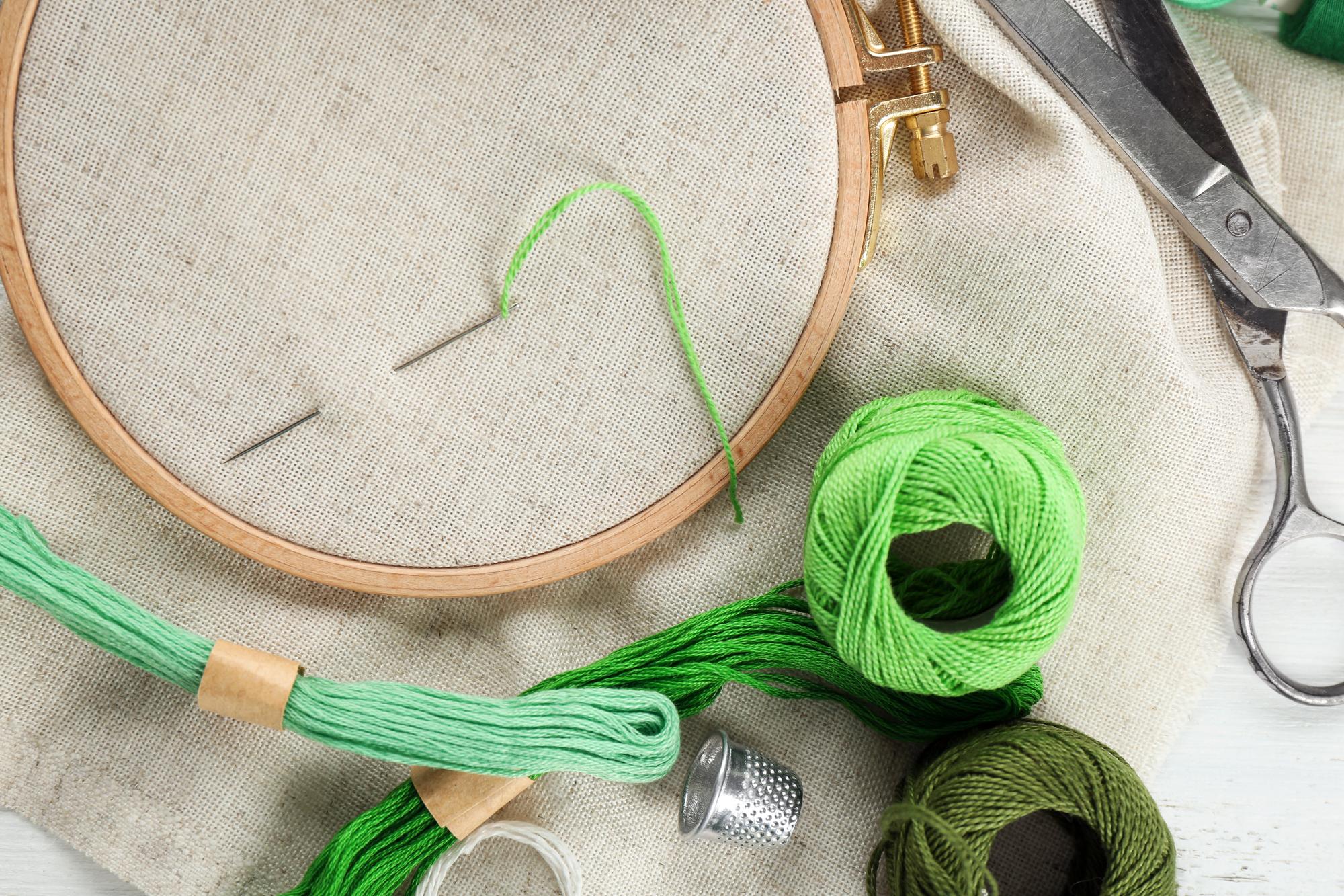 artist at work stitching a branded patch